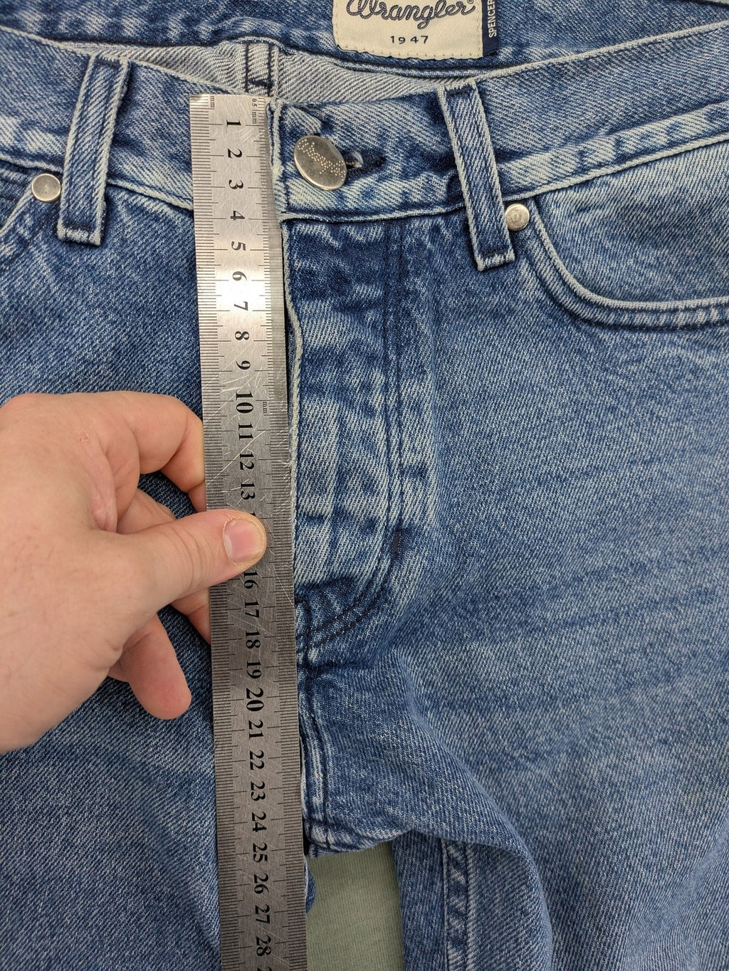 Wrangler blue straight jeans with button fly and classic 5-pocket design.