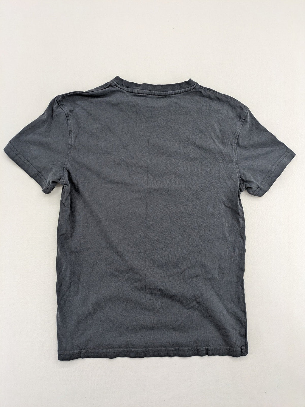 Harry Potter blue t-shirt featuring colorful Hogwarts crest and "I'd Rather Be At Hogwarts" slogan.