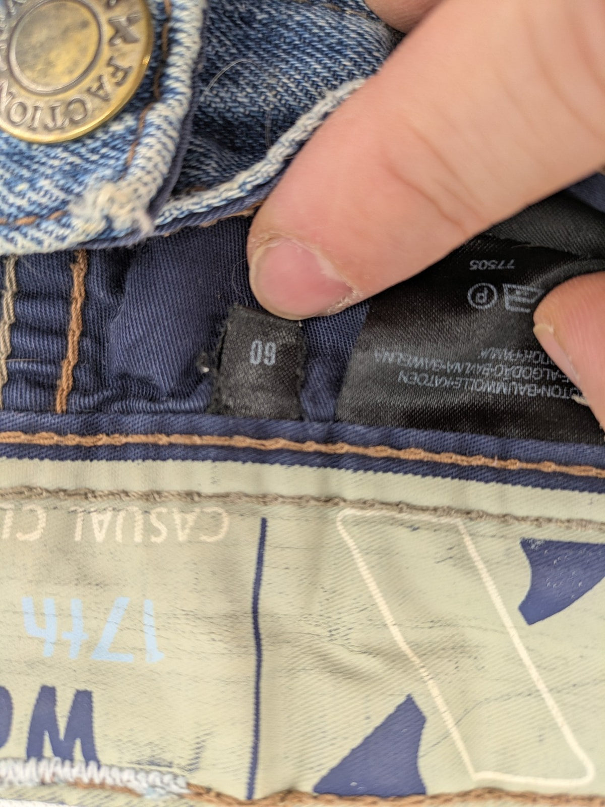 C&A blue straight jeans 5-pocket style with logo and button closure.