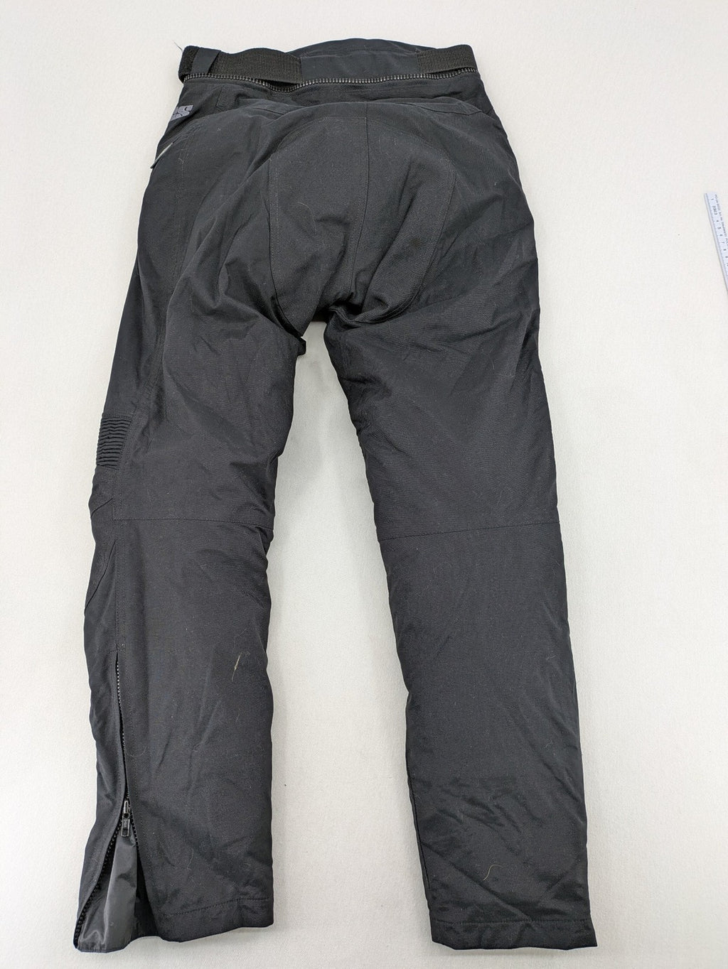 iXS black chaps with grey accents, waterproof textile, adjustable belt, reinforced knees.