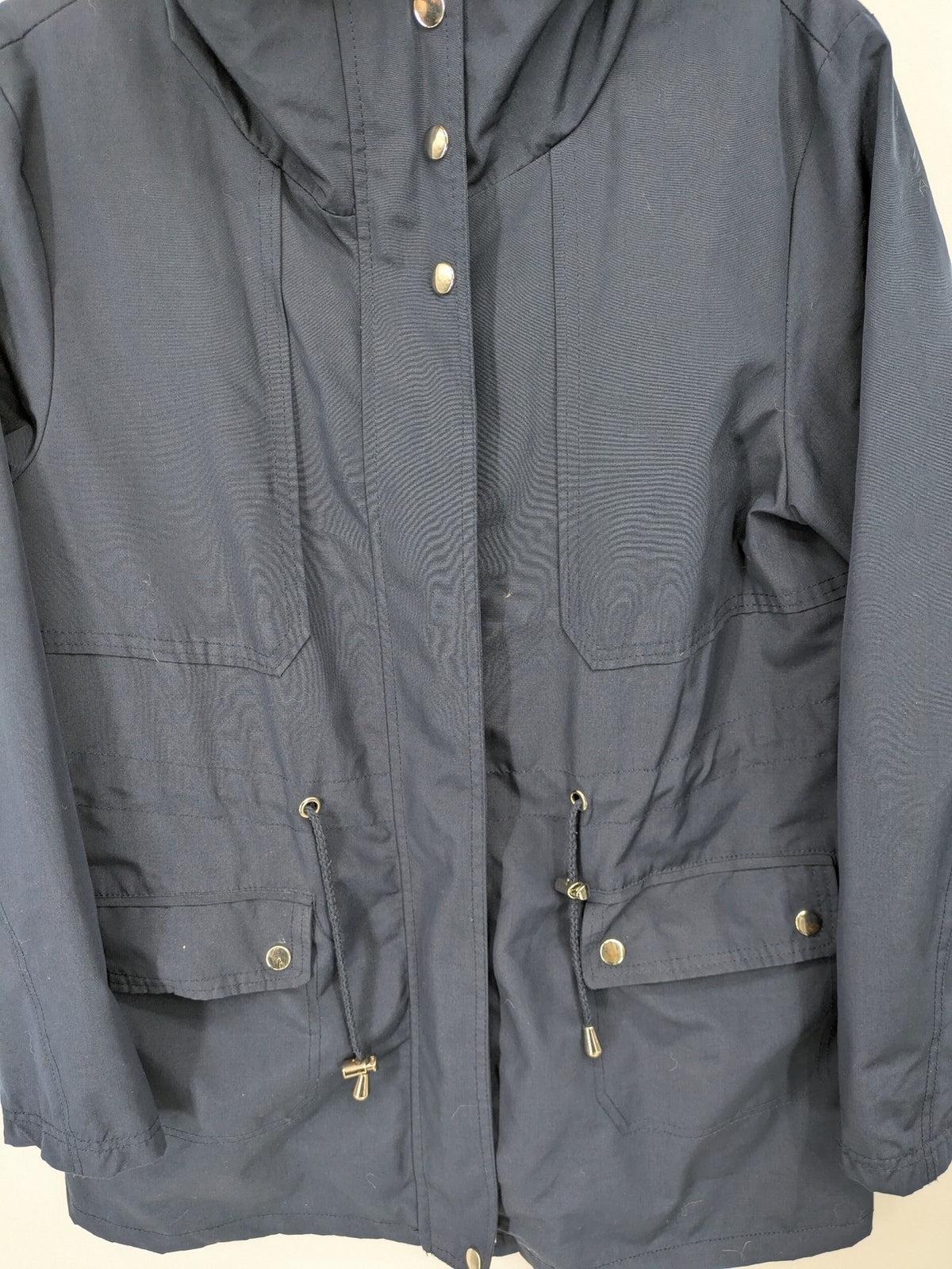 Janina navy anorak jacket with high collar and adjustable drawstring waist.