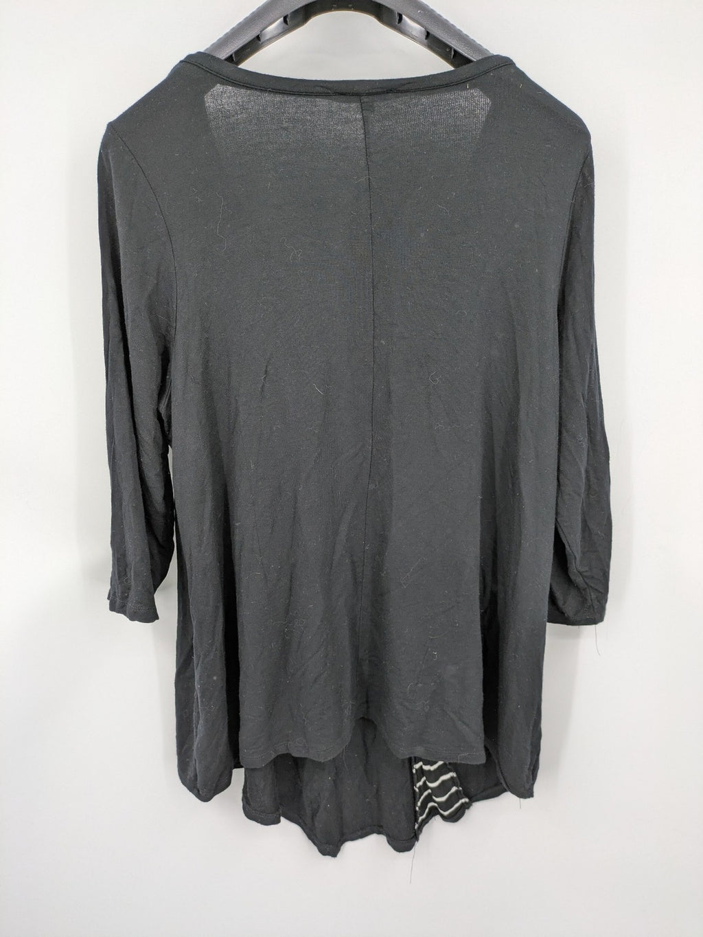 Cupio black long sleeve tunic with side button placket and high-low hem.