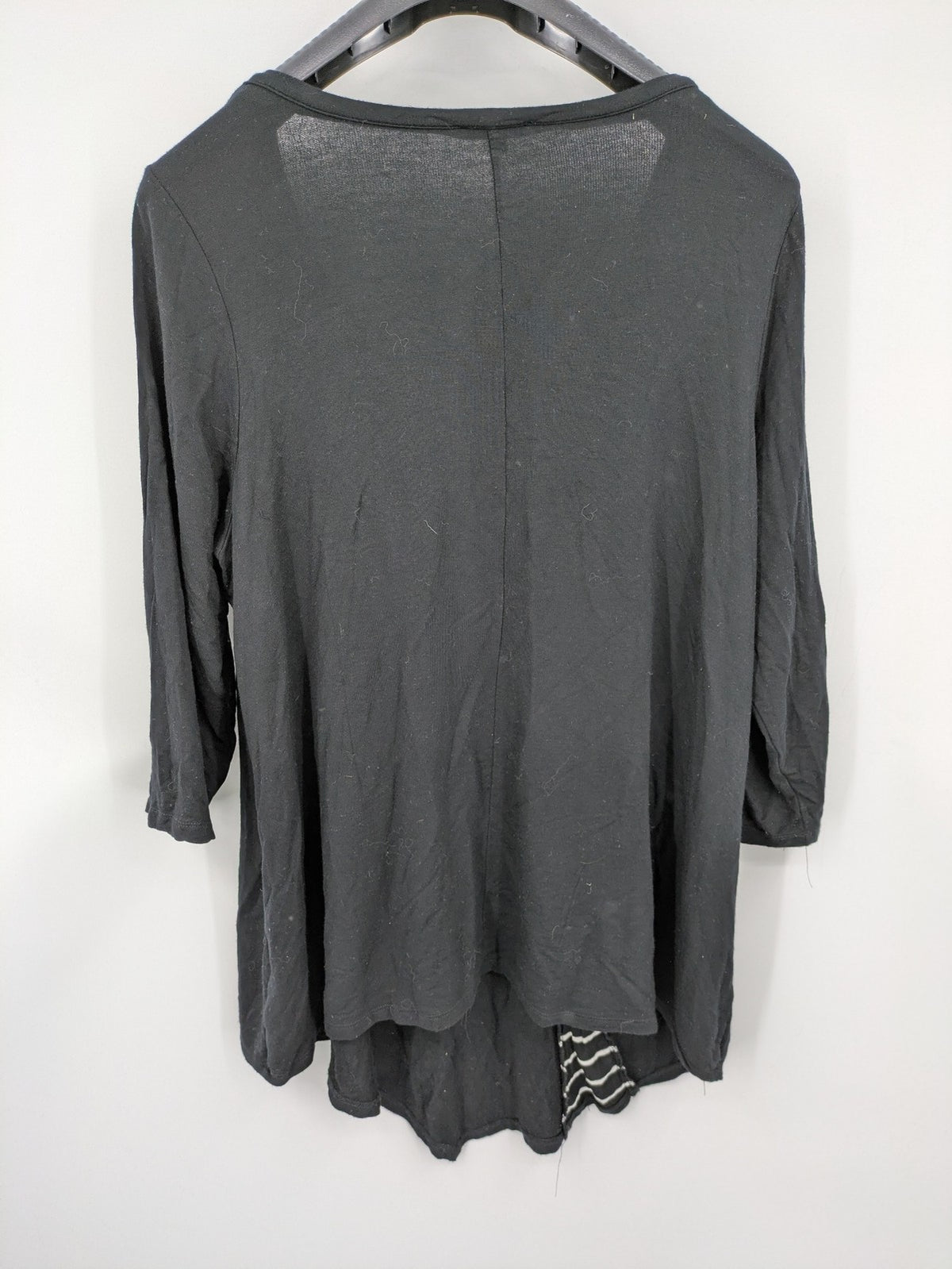 Cupio black long sleeve tunic with side button placket and high-low hem.