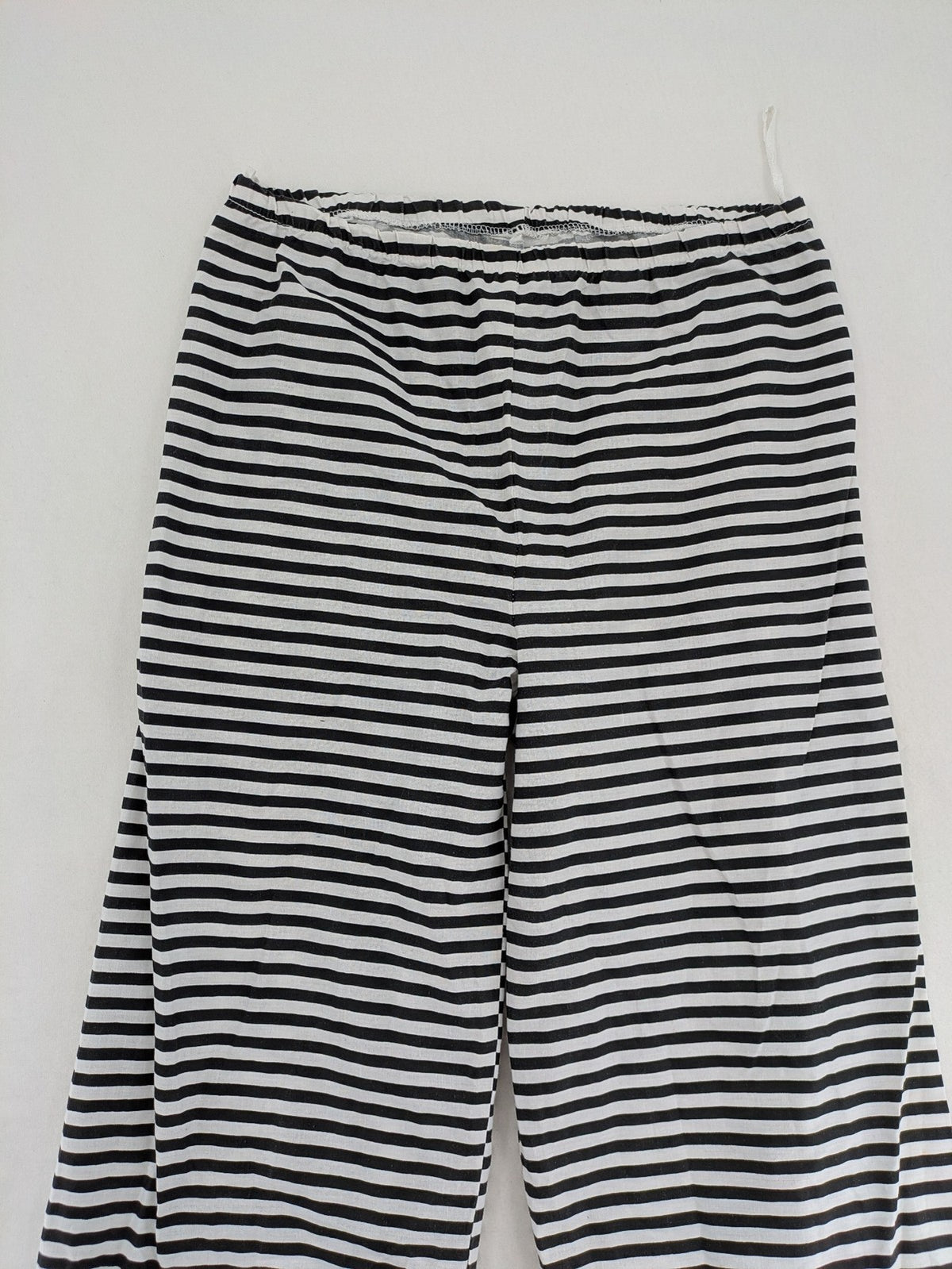 Rubie's costume set black and white striped with prisoner number patch on chest.
