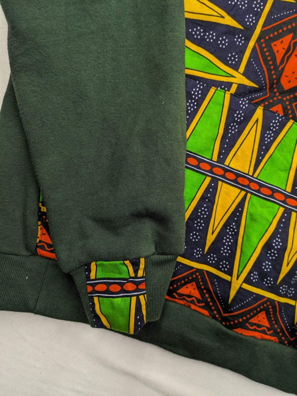 Diweye Creations multi turtle neck jumper with vibrant African print and soft green material.