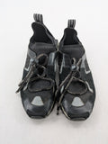 Dolce & Gabbana black sneakers with logo laces and segmented sole design.