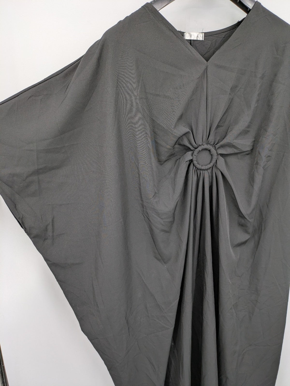 R.R grey kaftan dress with V-neck, oversized fit, and central ring detail.