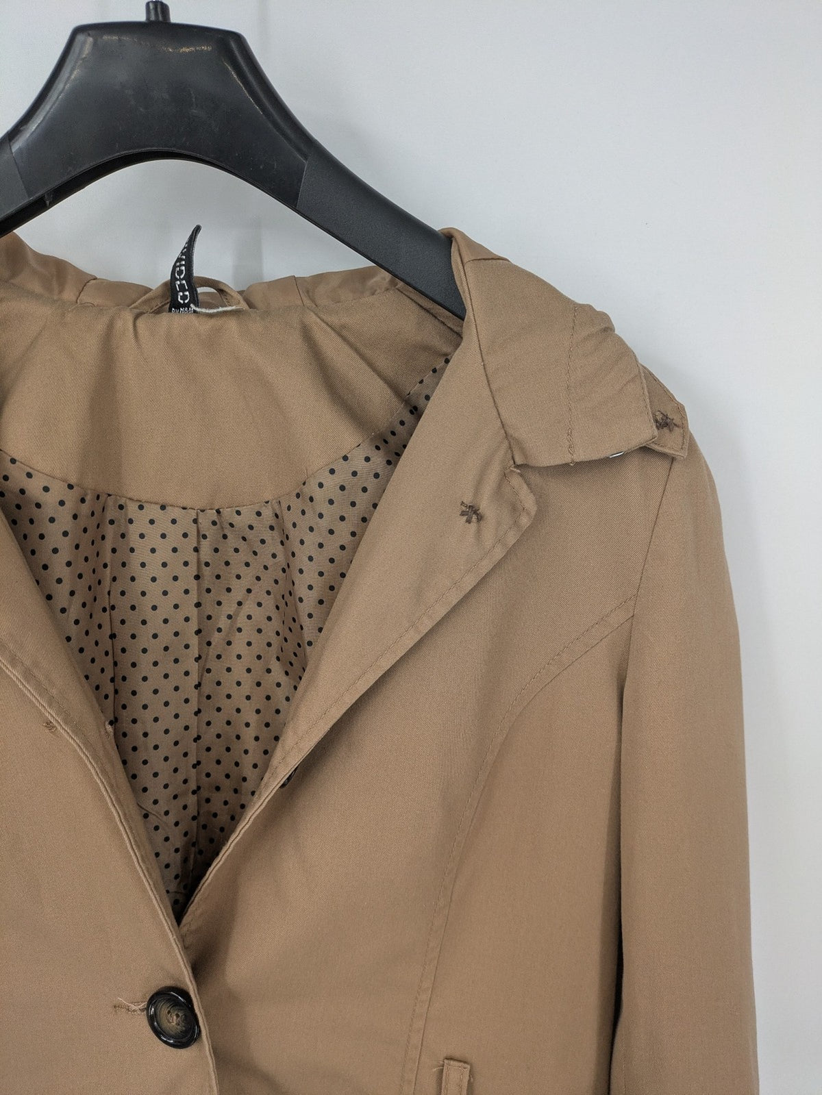 H&M Divided beige trench coat with button closure, hood, and polka dot lining.