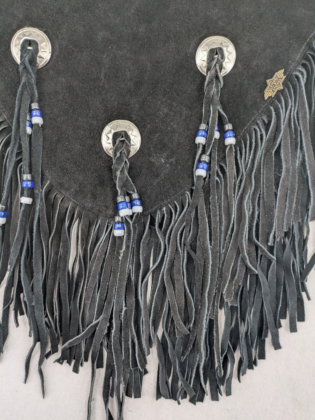 Stars & Stripes black suede fringe vest with silver conchos and beaded tassels.