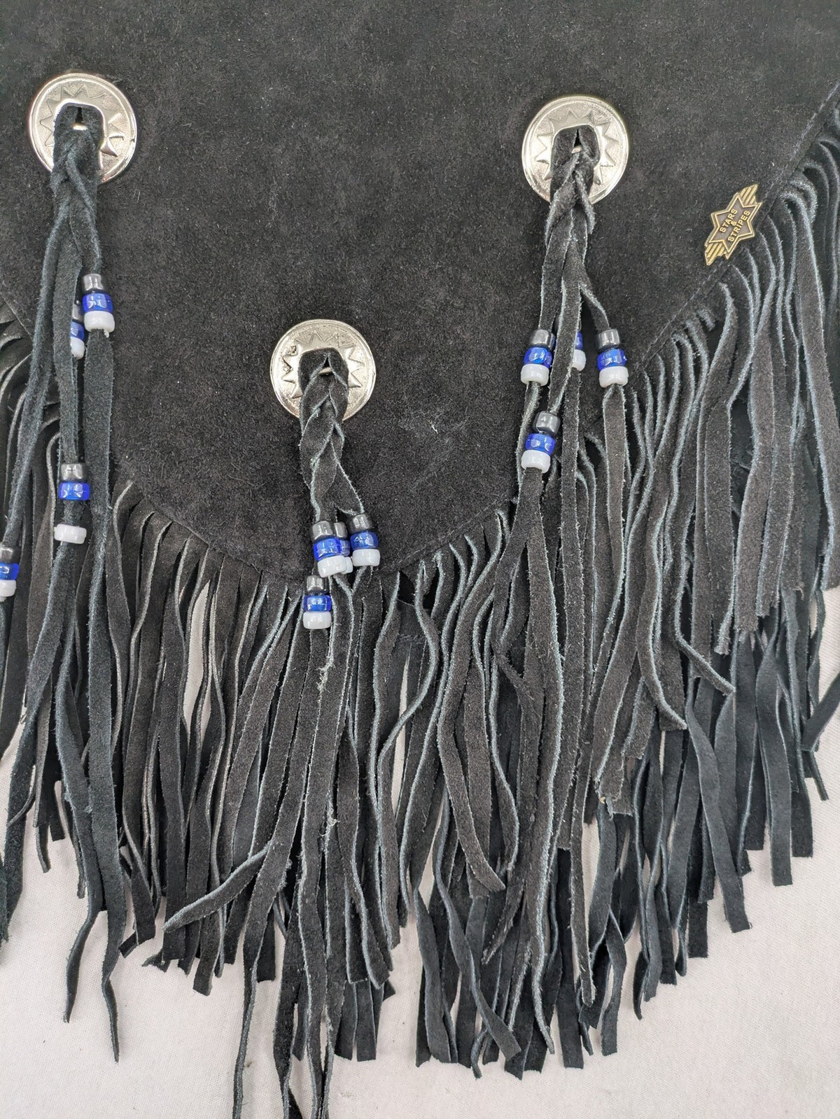 Stars & Stripes black suede fringe vest with silver conchos and beaded tassels.