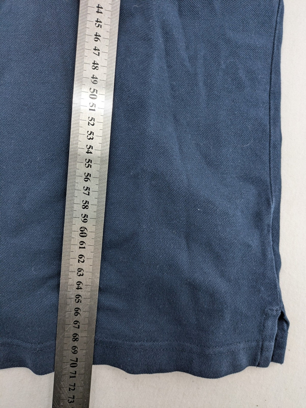 Hollister polo shirt navy blue with embroidered seagull logo and green trim.