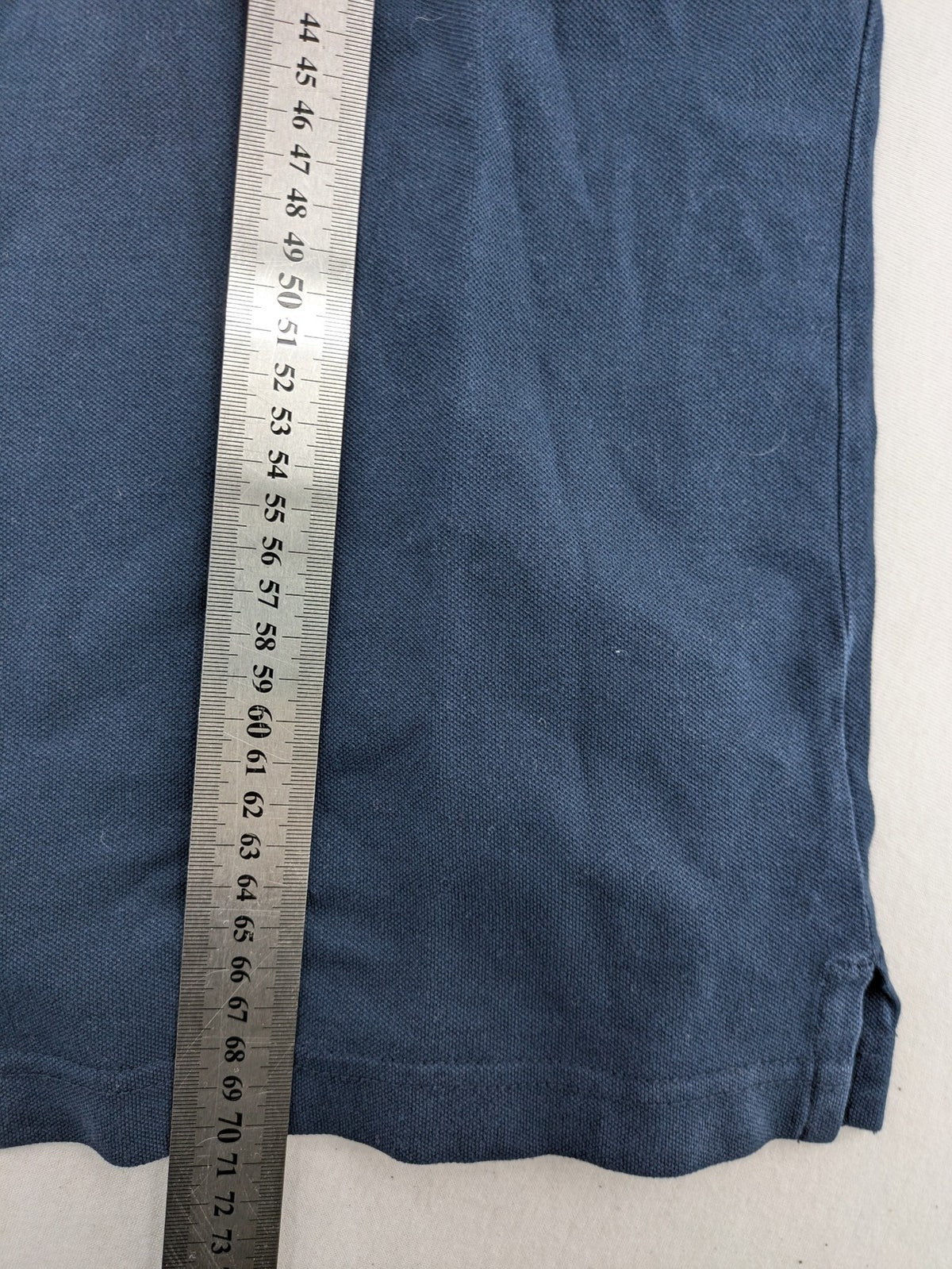 Hollister polo shirt navy blue with embroidered seagull logo and green trim.