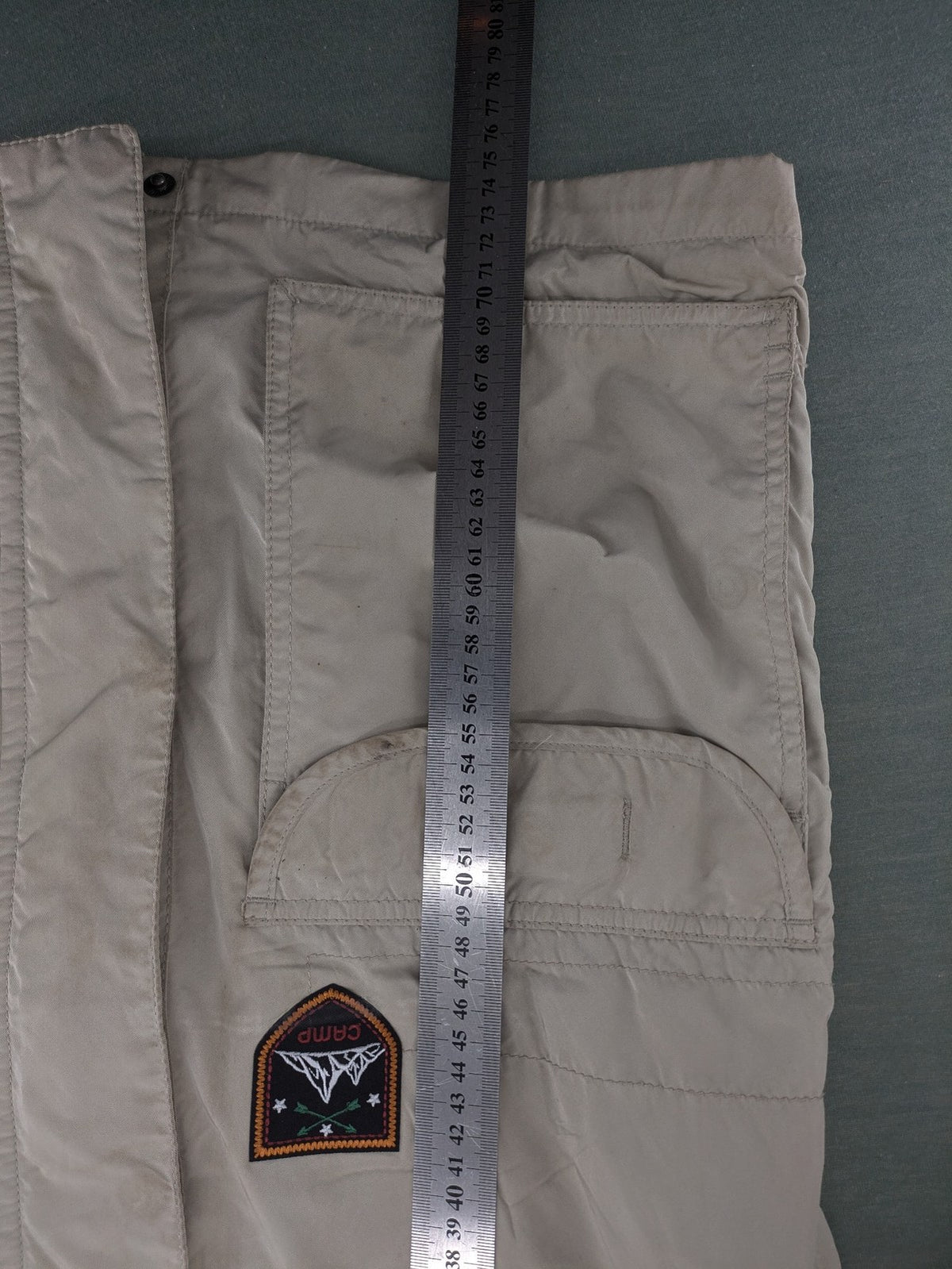 Camp David beige field jacket with logo patches, standing collar, and multiple pockets.