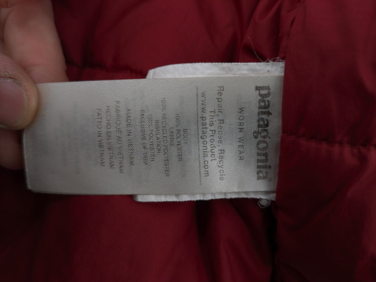 Patagonia red winter coat with hood, zip closure, snow skirt, and ski pass pocket.