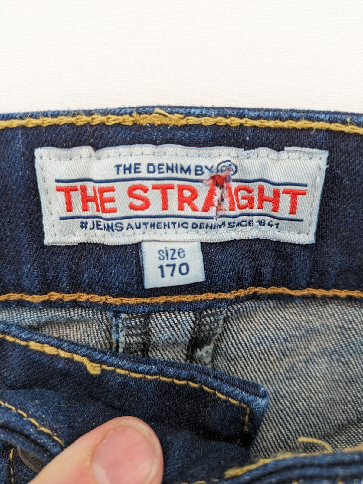 The Straight blue straight leg jeans with contrast stitching and 5-pocket design.