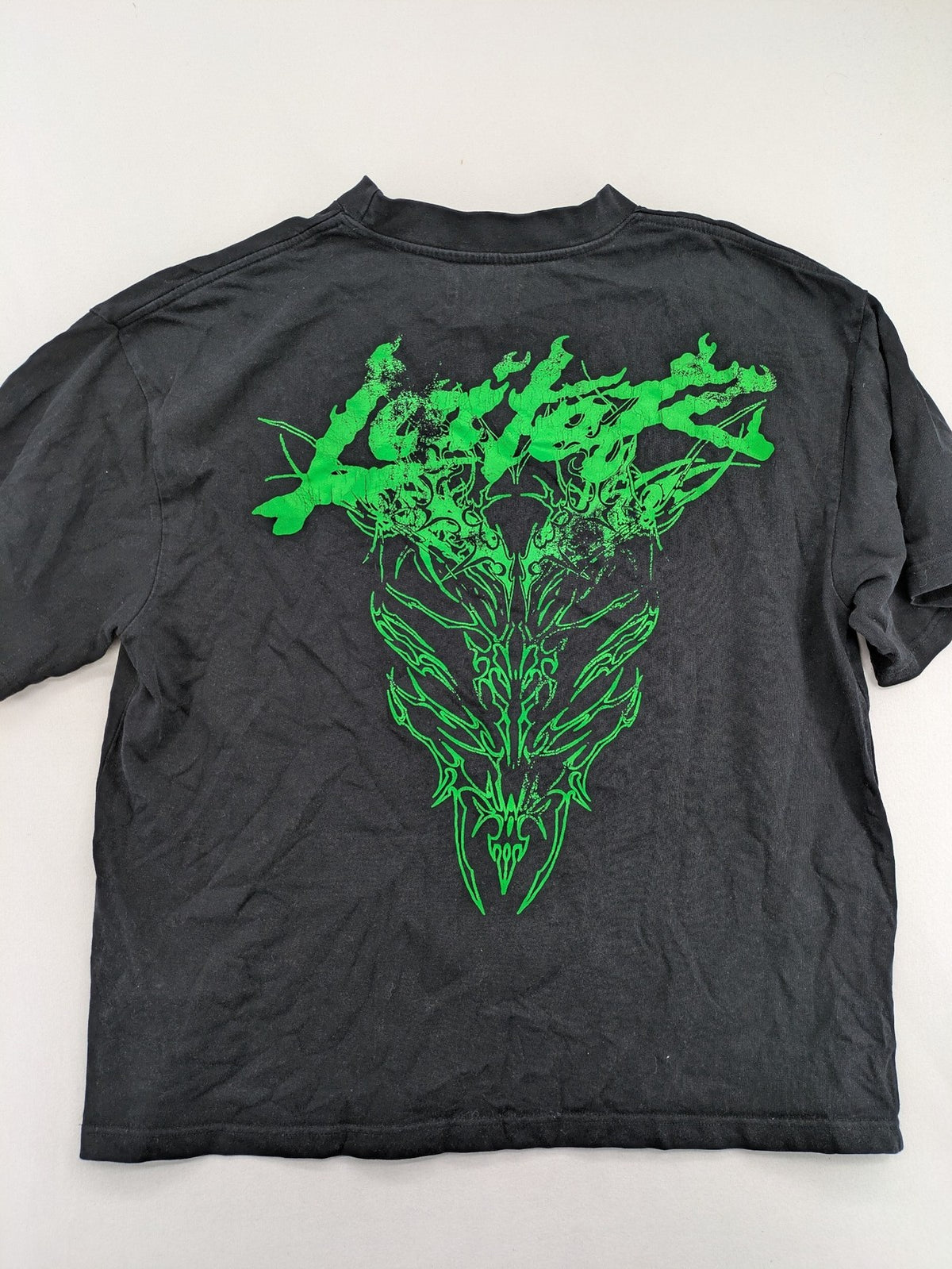 Lotter XL t-shirt black with neon green tribal graphic print on front and back.