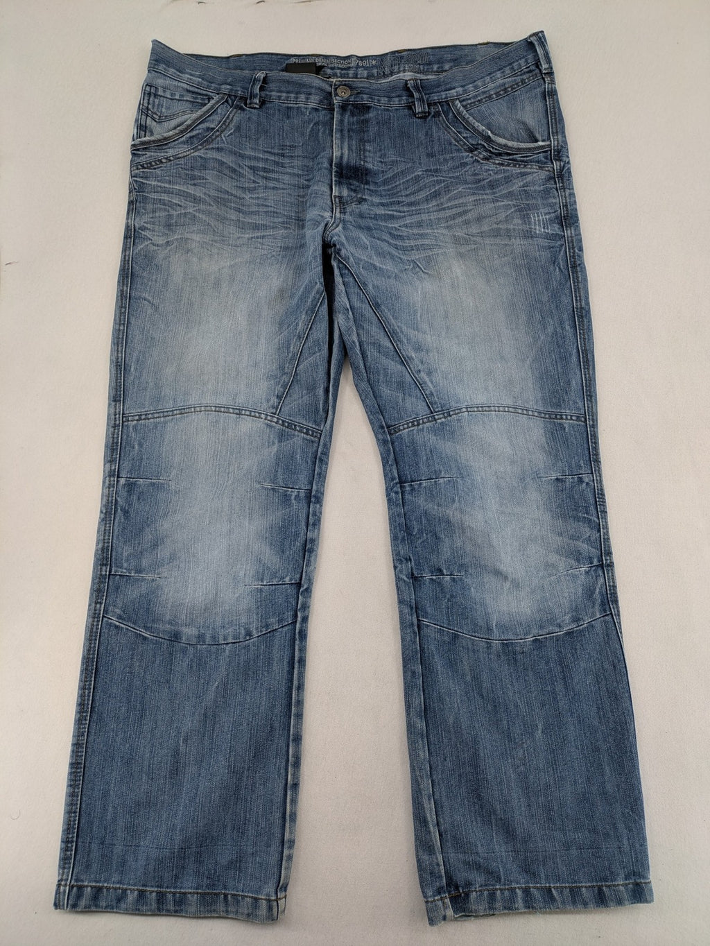 Premium Denim blue straight leg jeans with biker knee inserts and five-pocket design.