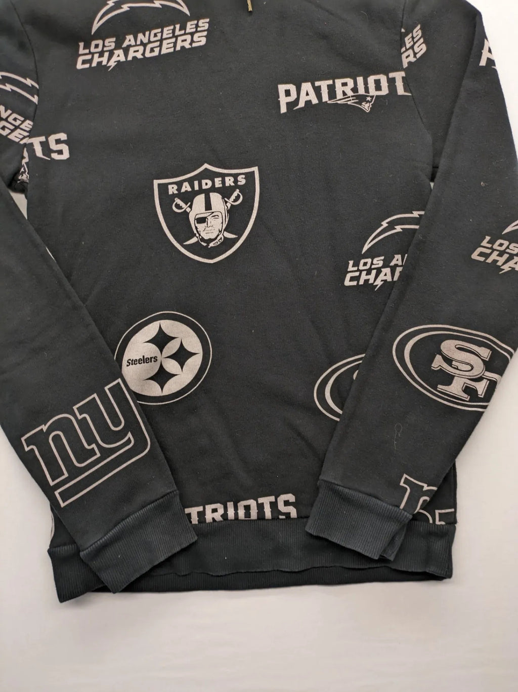 NFL black hoodie all-over team logo print, adjustable hood, cotton blend material.