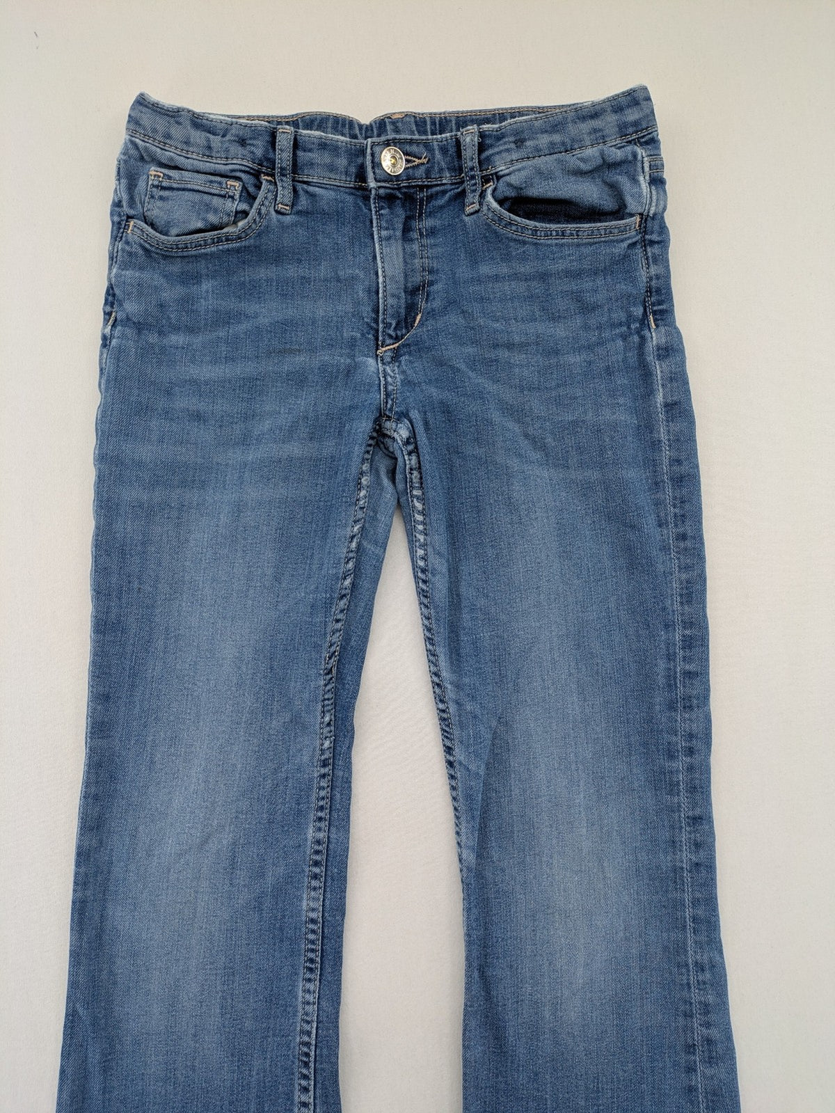 H&M blue bootcut jeans size 146, medium wash, stretch denim material.