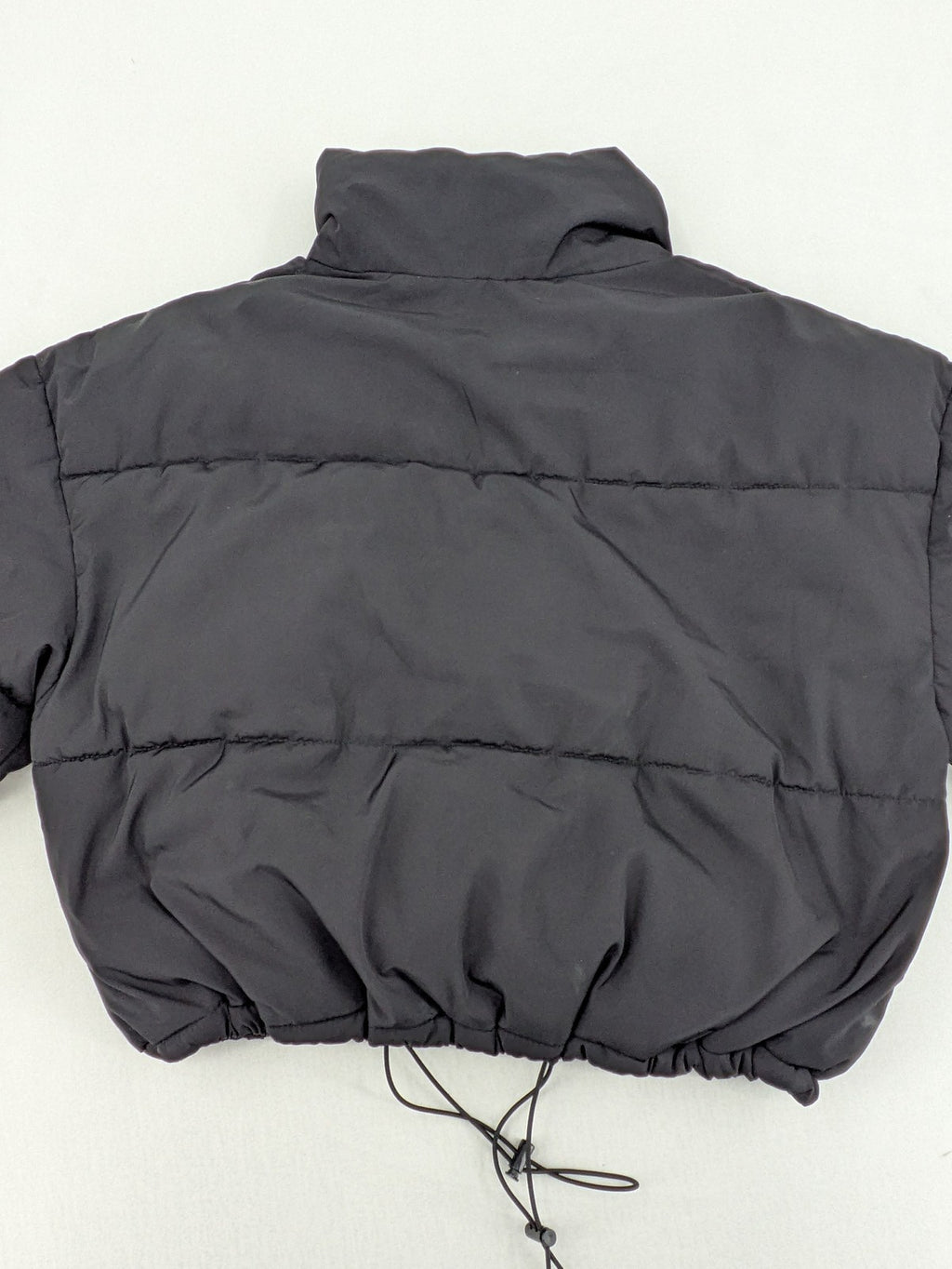 H&M Divided black cropped puffer jacket with zip closure and high collar.