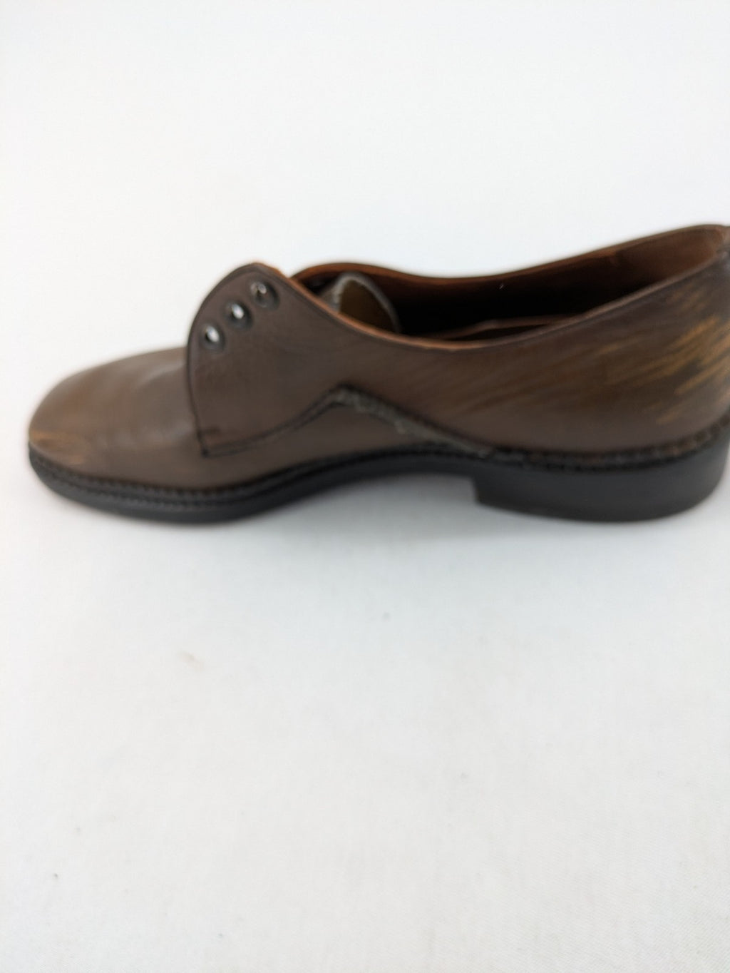 Fonda brown deck shoes genuine leather square toe design with decorative stitching.