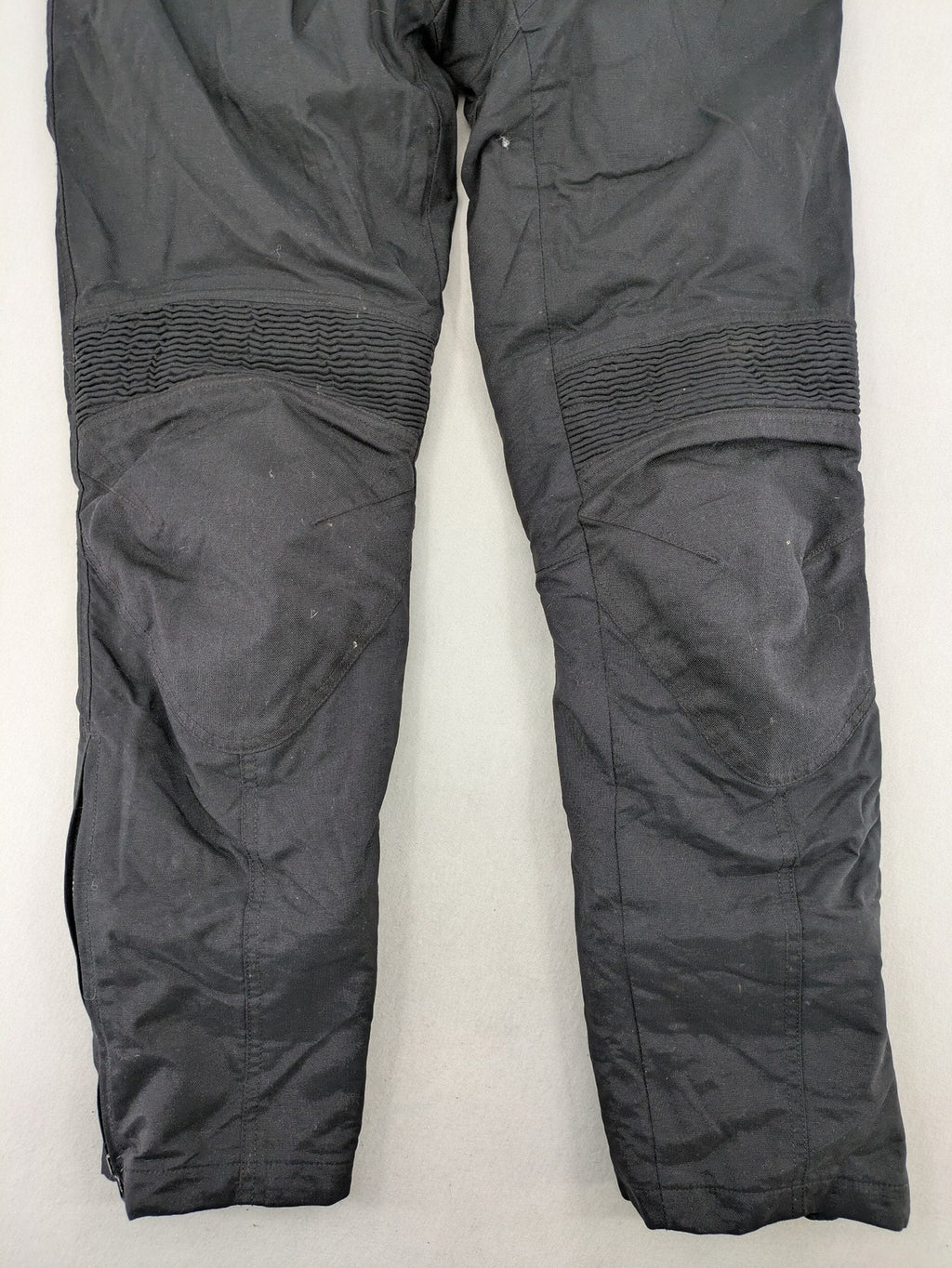 iXS black chaps with grey accents, waterproof textile, adjustable belt, reinforced knees.
