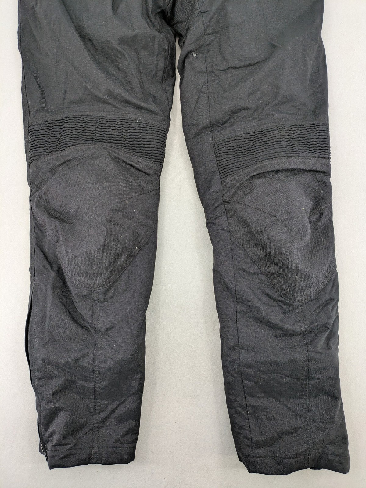 iXS black chaps with grey accents, waterproof textile, adjustable belt, reinforced knees.