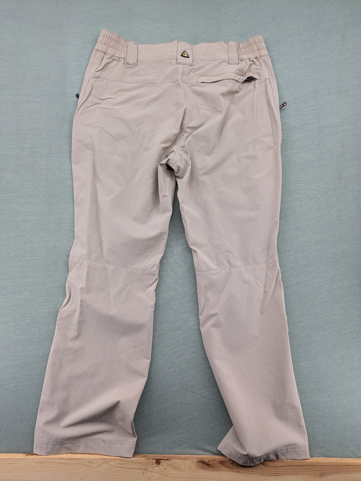 Hickory beige outdoor pants with multiple zippered pockets and stretch fabric for comfort.