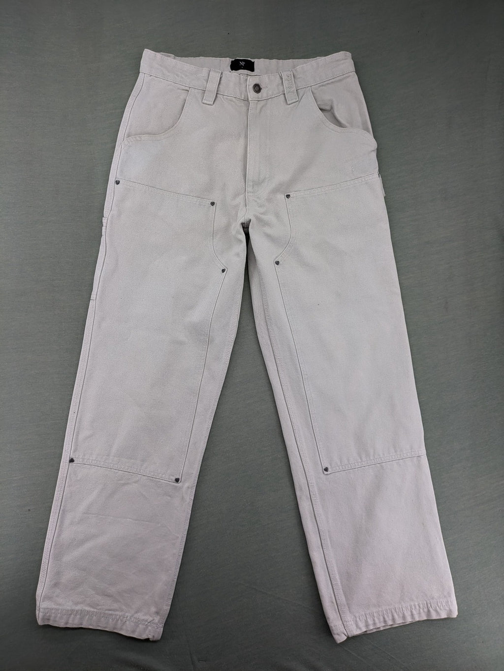 NUDE beige pants with double knee reinforcements and multiple utility pockets.