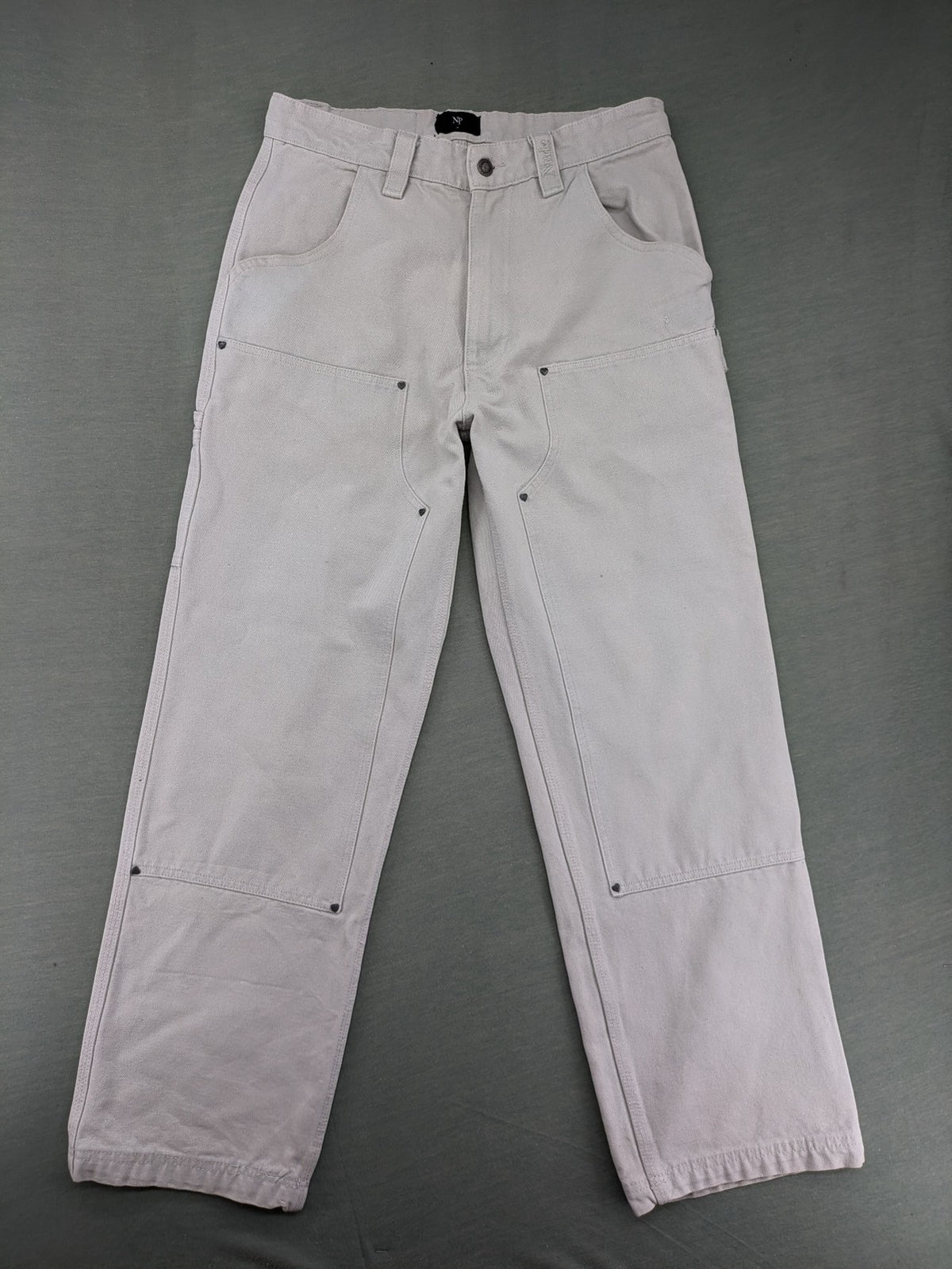 NUDE beige pants with double knee reinforcements and multiple utility pockets.