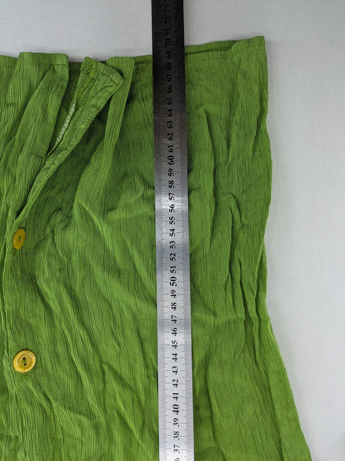 Expressions green blouse with V-neck, button front, and crinkle texture.