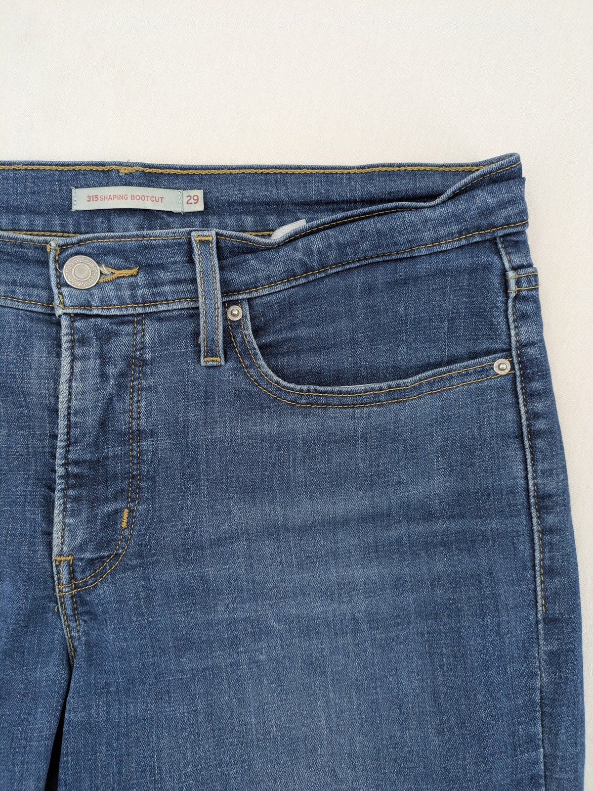Levi's blue denim Bermuda shorts with rolled cuffs and classic 5-pocket design.