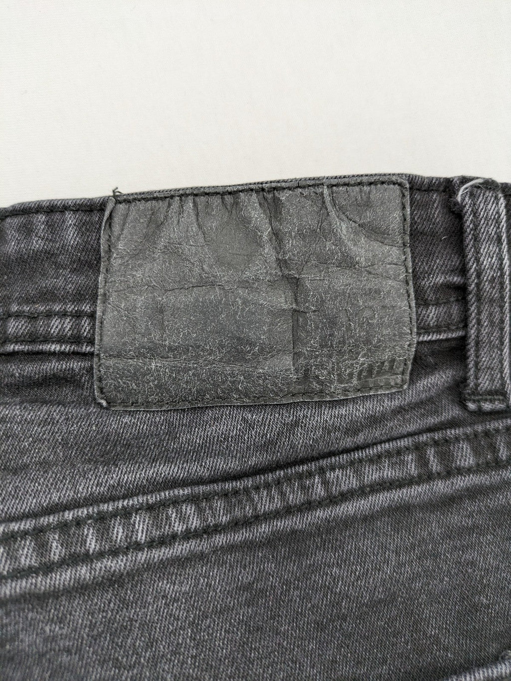 Black Squad skinny fit jeans black distressed ripped design with subtle paint splatter.