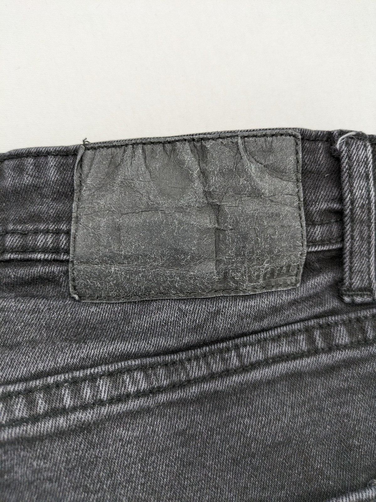 Black Squad skinny fit jeans black distressed ripped design with subtle paint splatter.