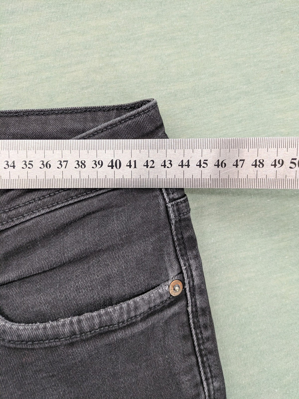 Jack & Jones black slim fit jeans faded wash stretch denim with logo detail.