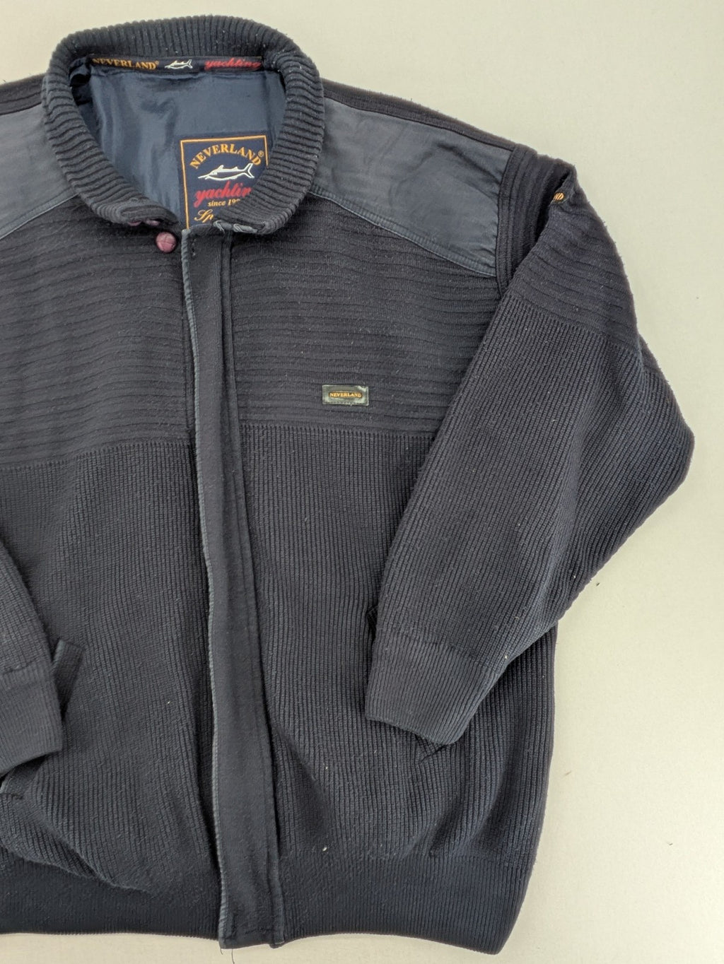Neverland grey and navy full zip turtle neck jumper with ribbed knit and shoulder patches.
