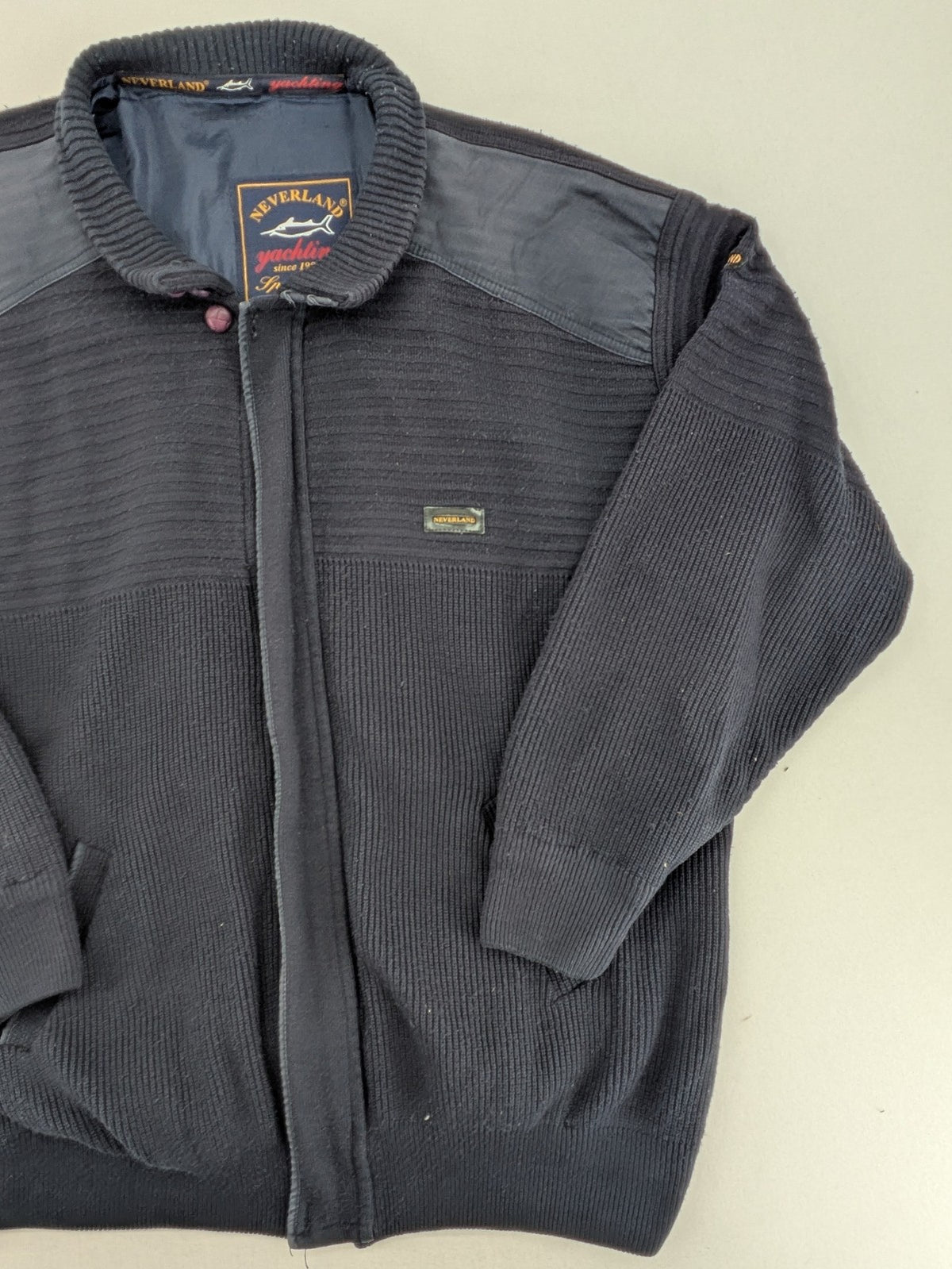 Neverland grey and navy full zip turtle neck jumper with ribbed knit and shoulder patches.