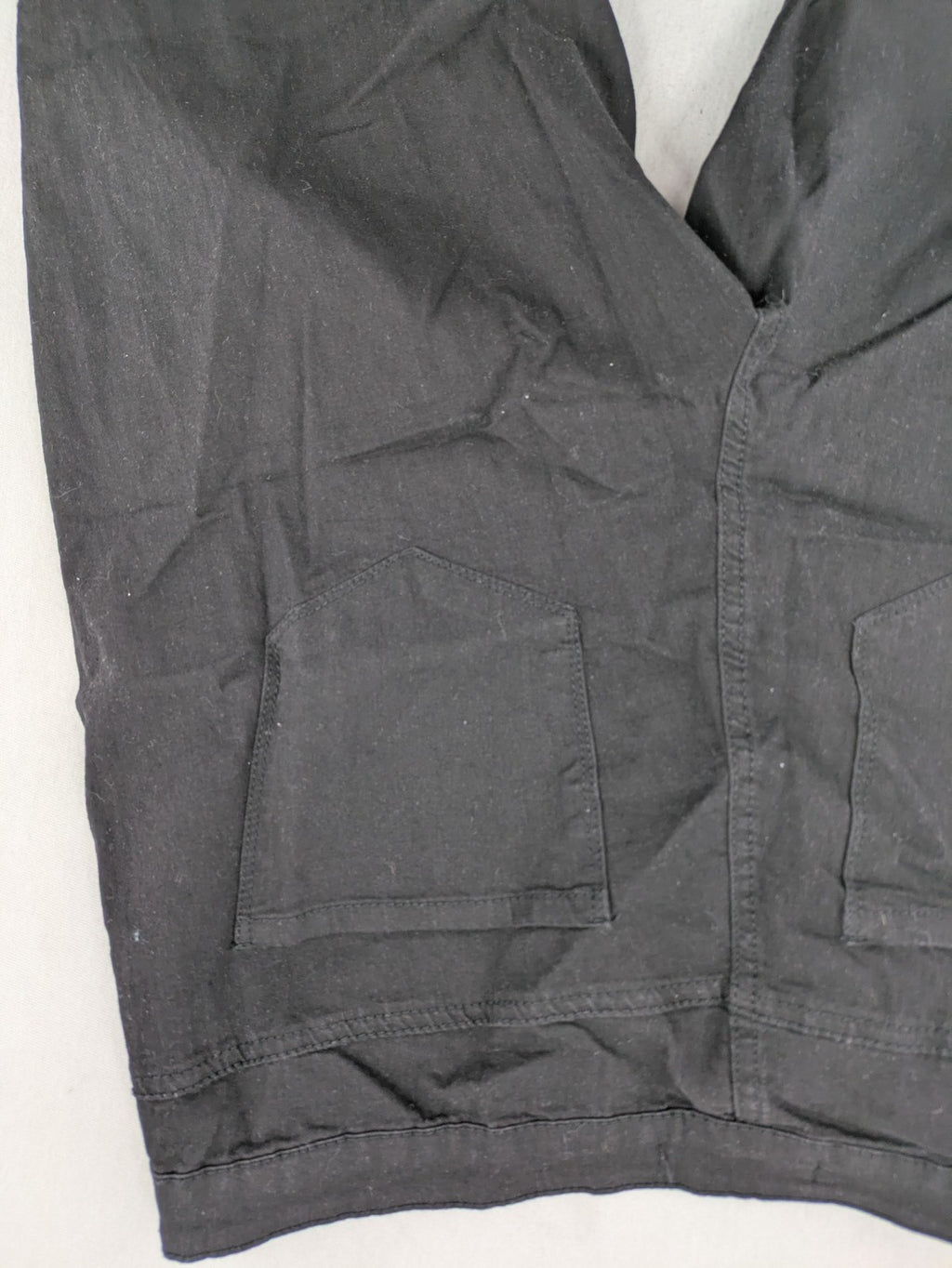 Denim & Co. black straight jeans with front button closure and back pockets.