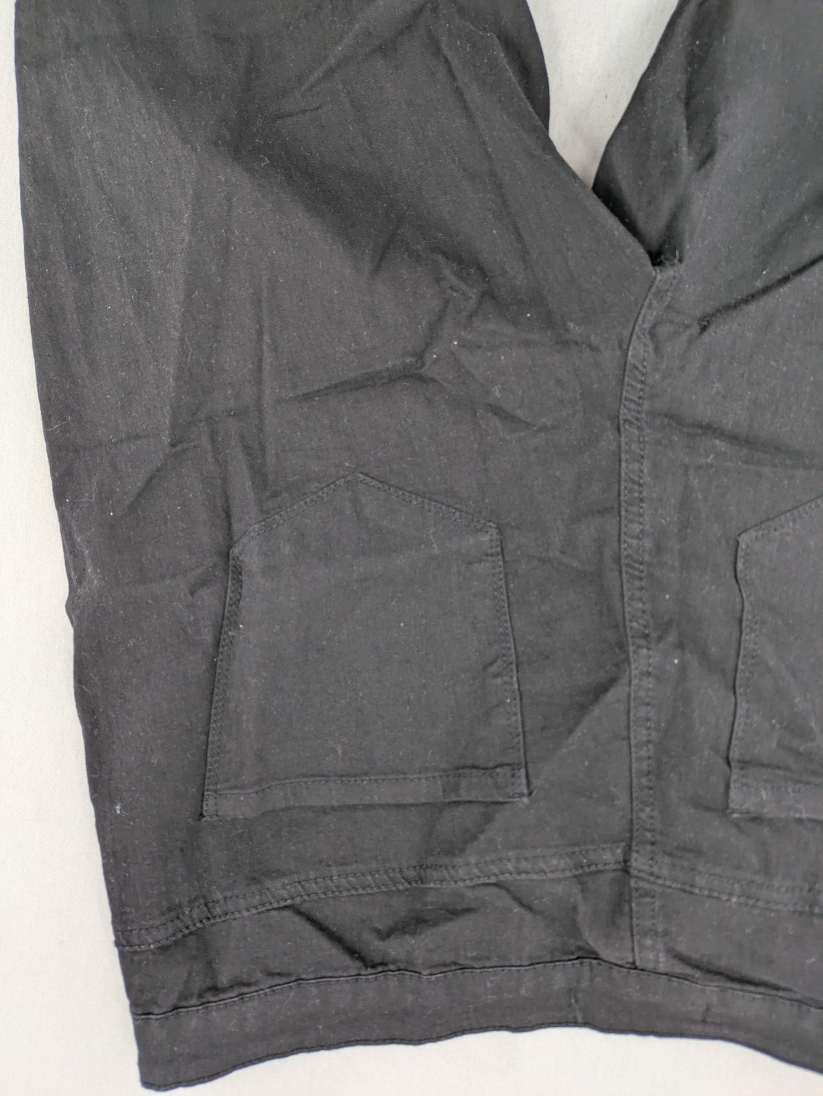 Denim & Co. black straight jeans with front button closure and back pockets.