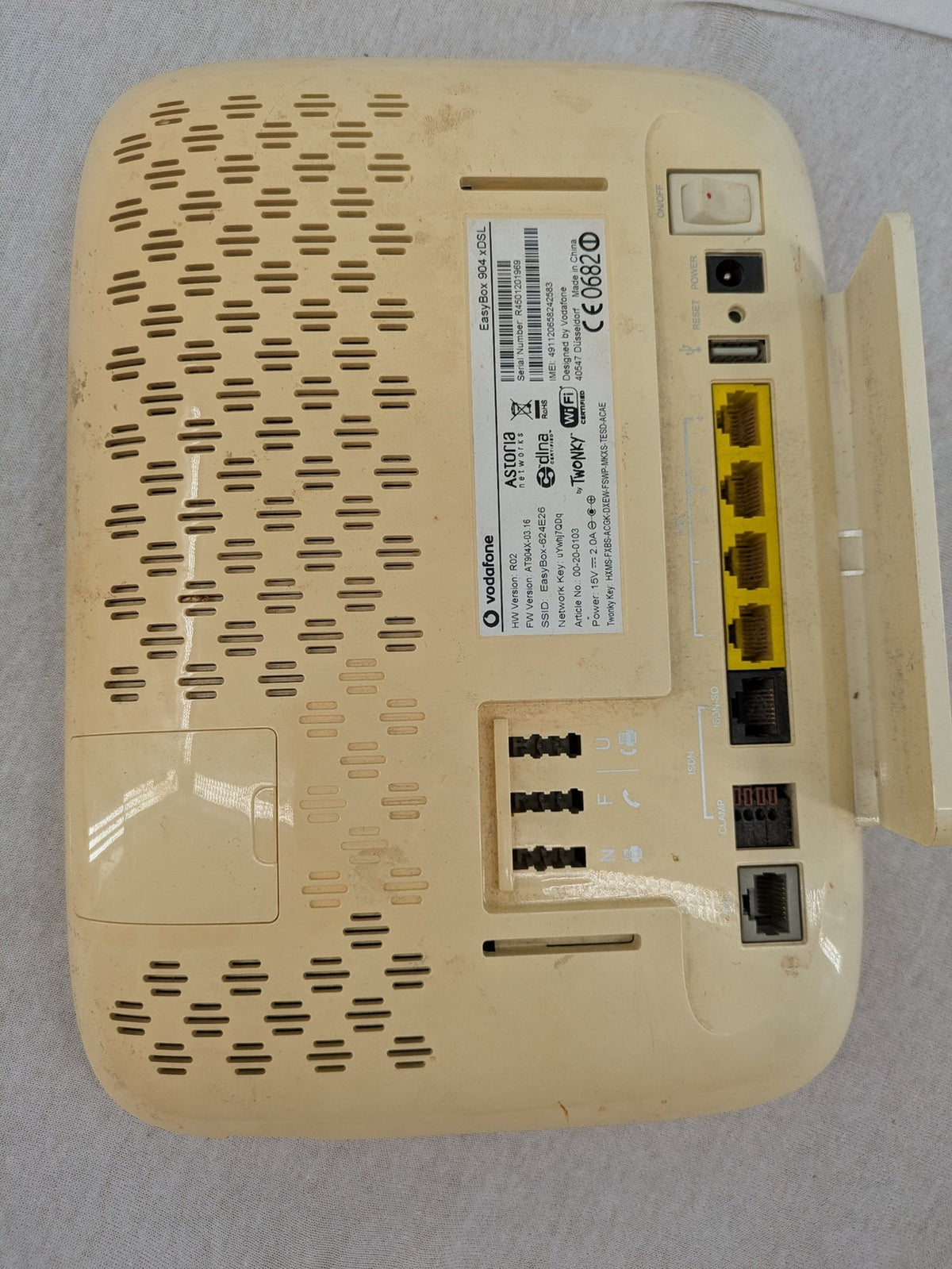 Vodafone beige wireless router with multiple LAN ports and DSL connectivity.