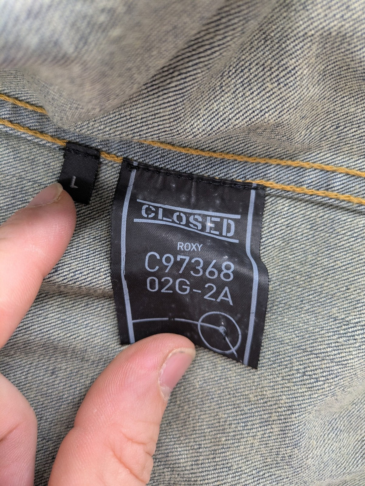 CLOSED blue denim trucker jacket with button front and two chest pockets.