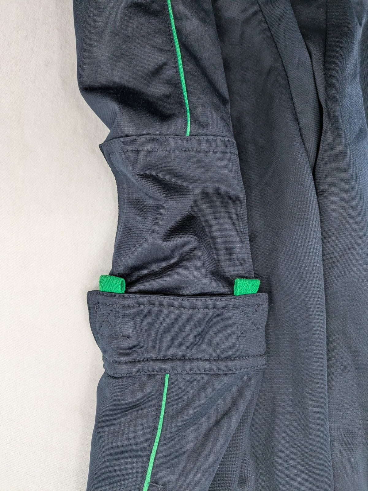 okay grey cargo shorts with green "ATHL. 5 DIVISION" graphic print and side pocket.