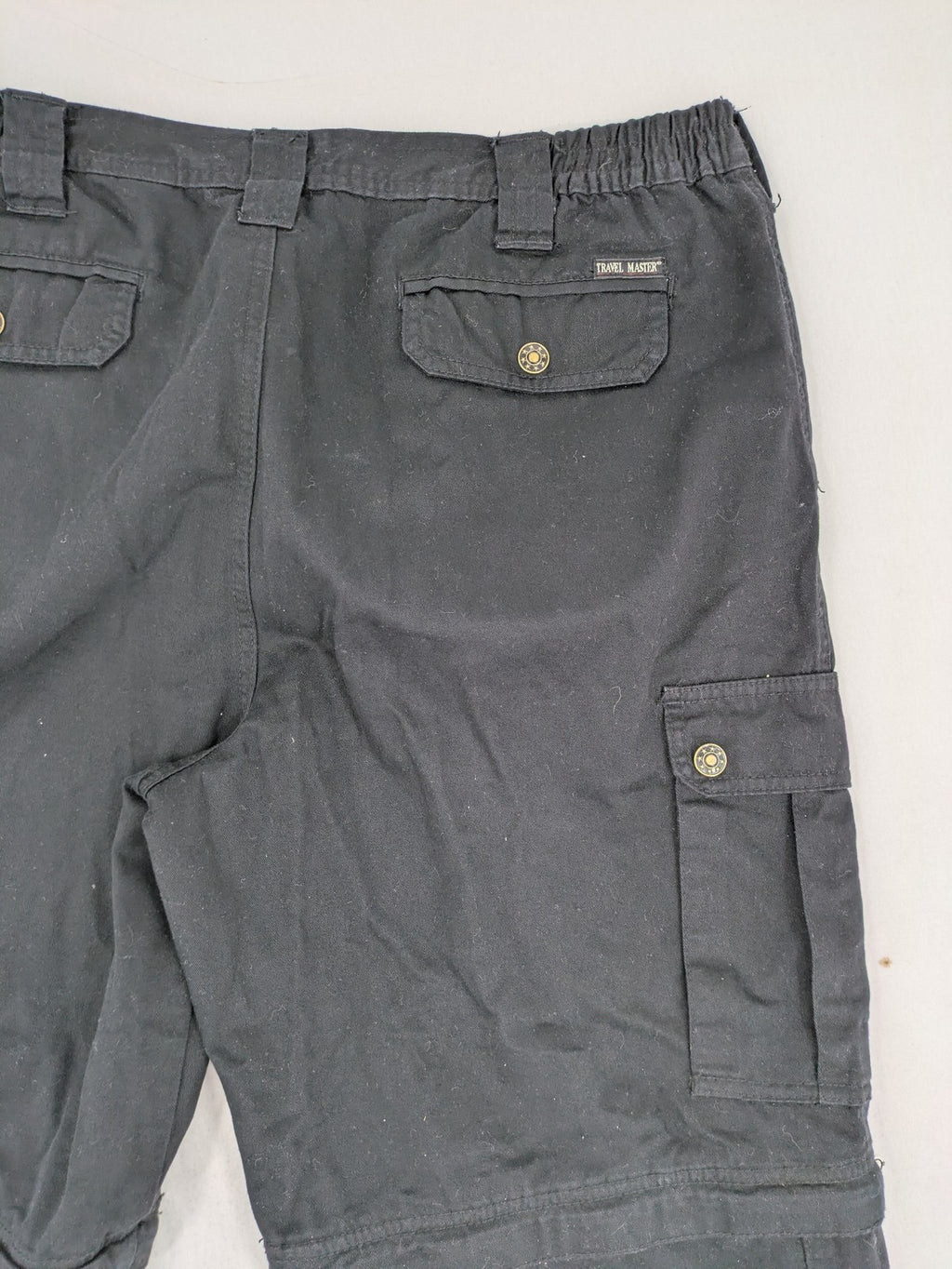 Travel Master black hunting and tactical pants, zip-off design, 100% cotton, multiple pockets.