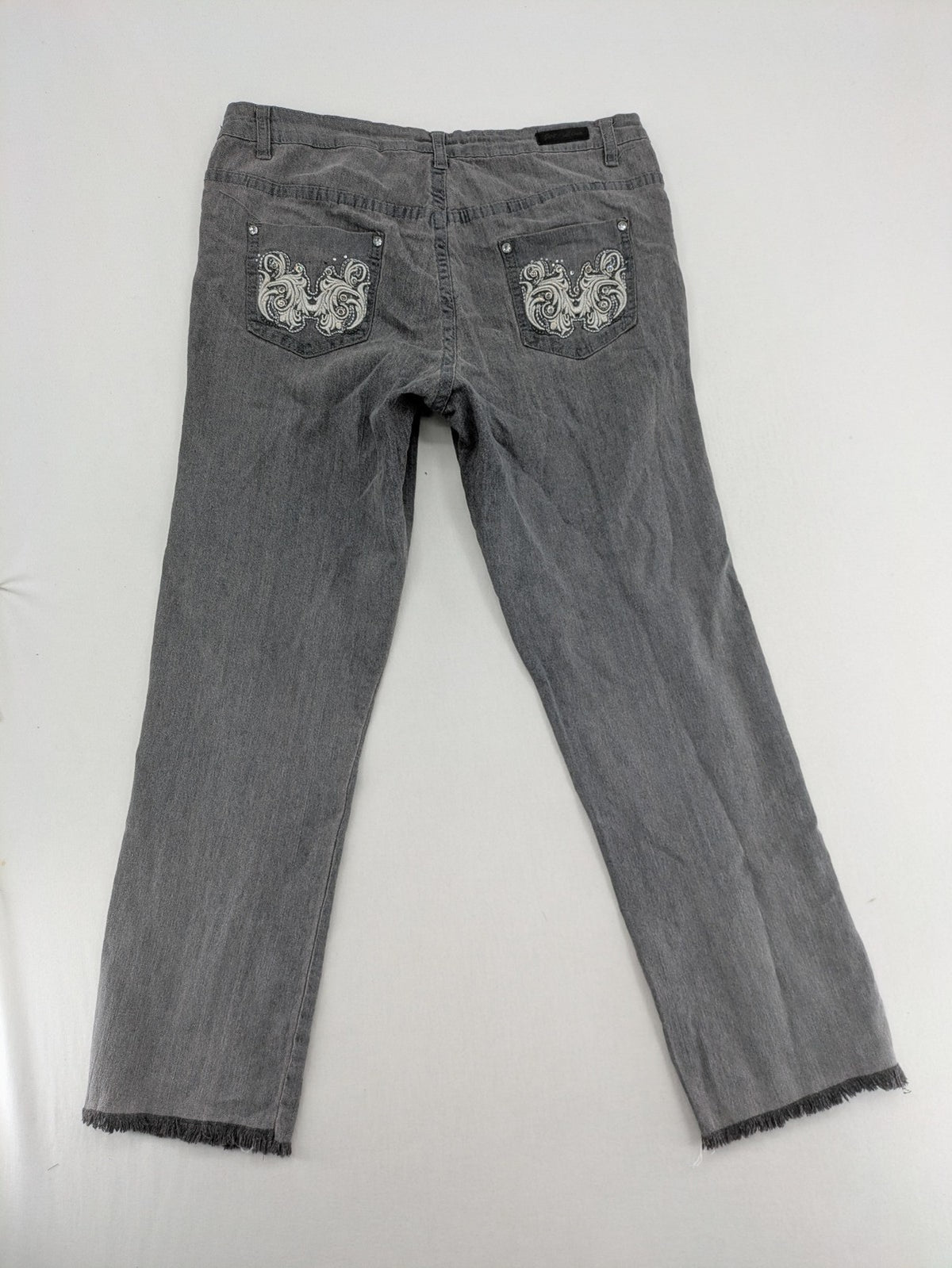 Jet Line grey straight jeans with embellished back pockets and frayed hem details.