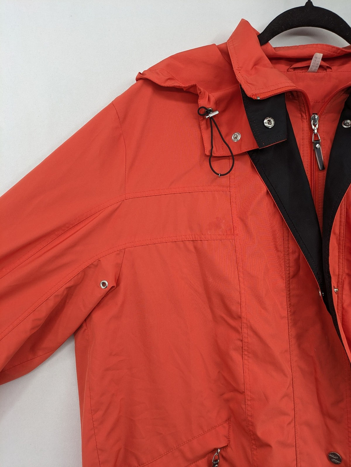 Sport Windbreaker orange jacket with adjustable hood, full zip, and button storm flap.