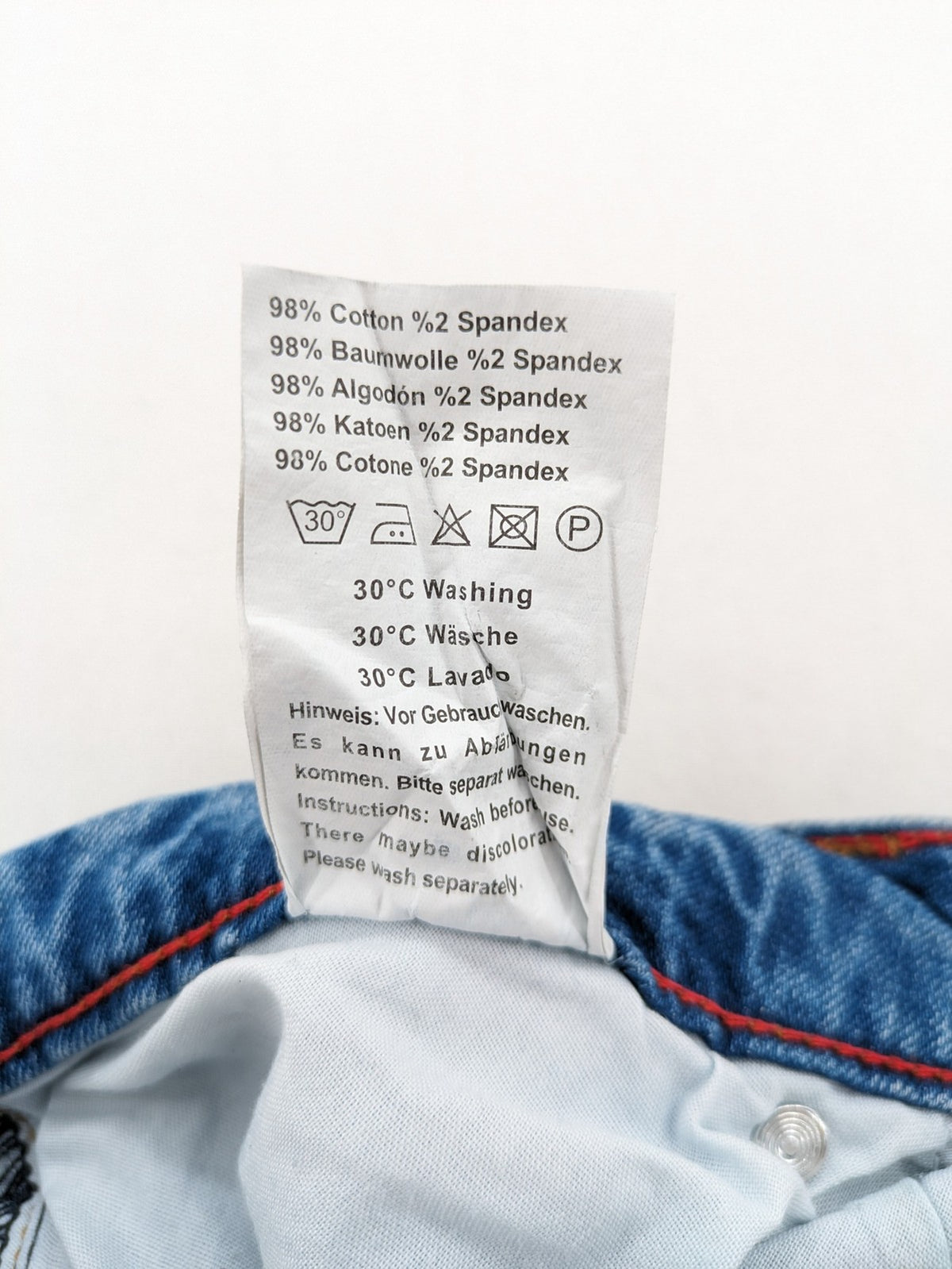 Milano straight jeans light blue distressed with red splatter and extra slim fit.