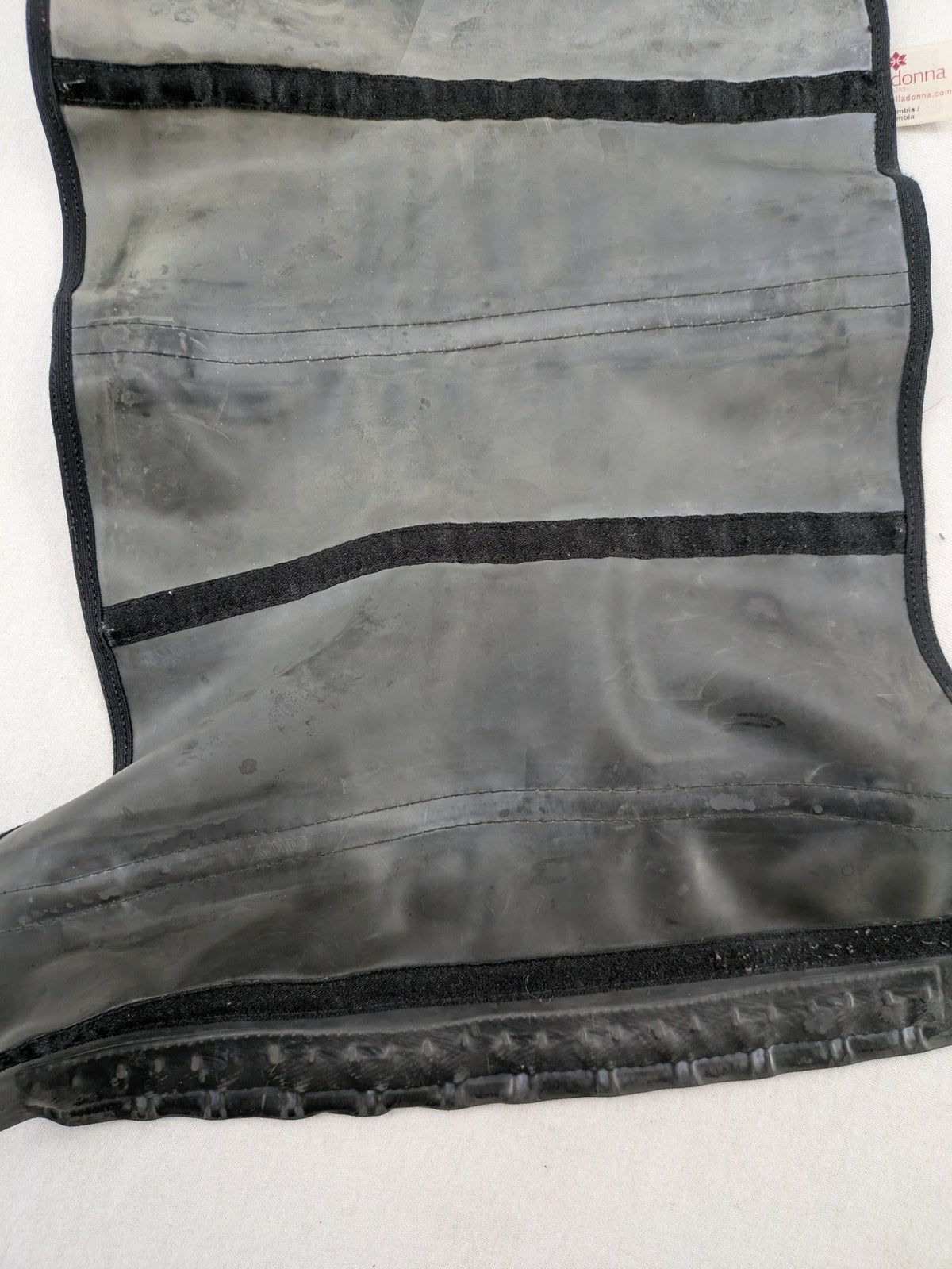 Faja black shapewear body shaper with multiple hook-and-eye closures and latex core.