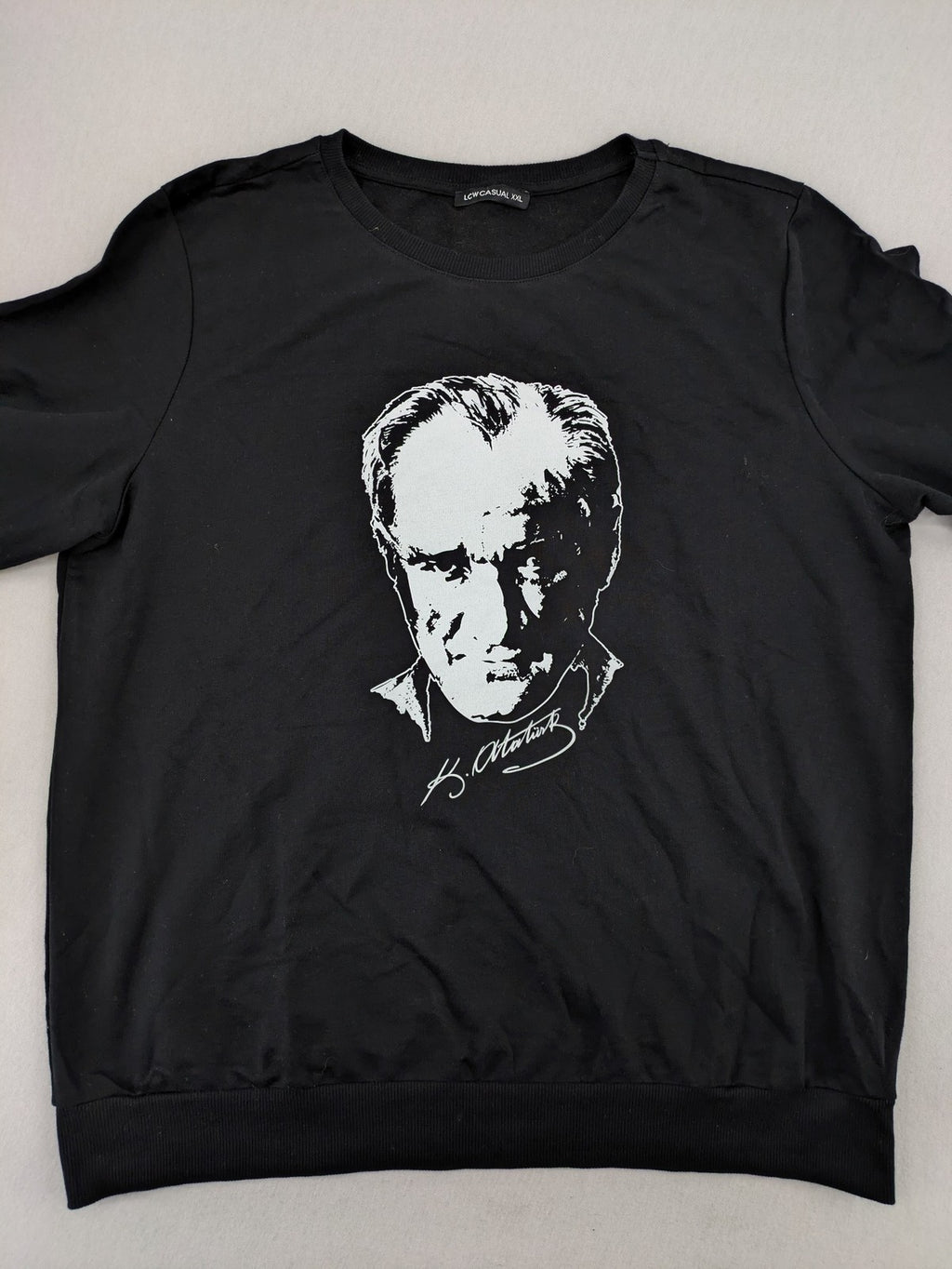LC Waikiki black turtle neck jumper featuring Atatürk graphic print and signature.