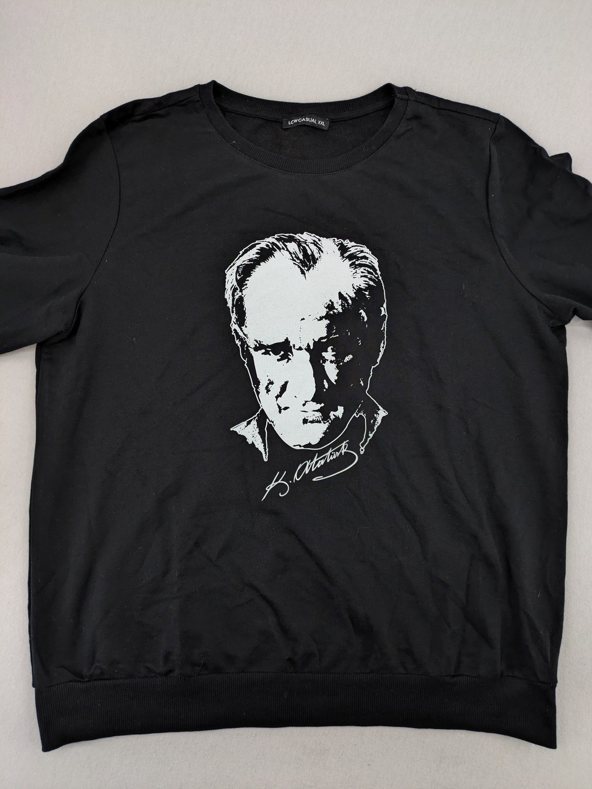LC Waikiki black turtle neck jumper featuring Atatürk graphic print and signature.