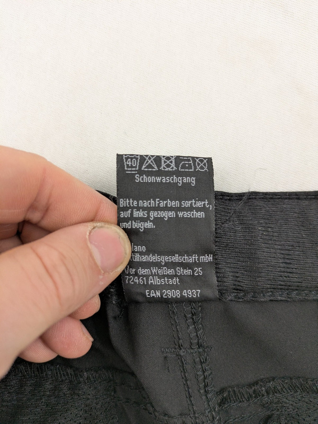 Outdoor grey trekking pants with zippered cargo pockets and durable stretch fabric.